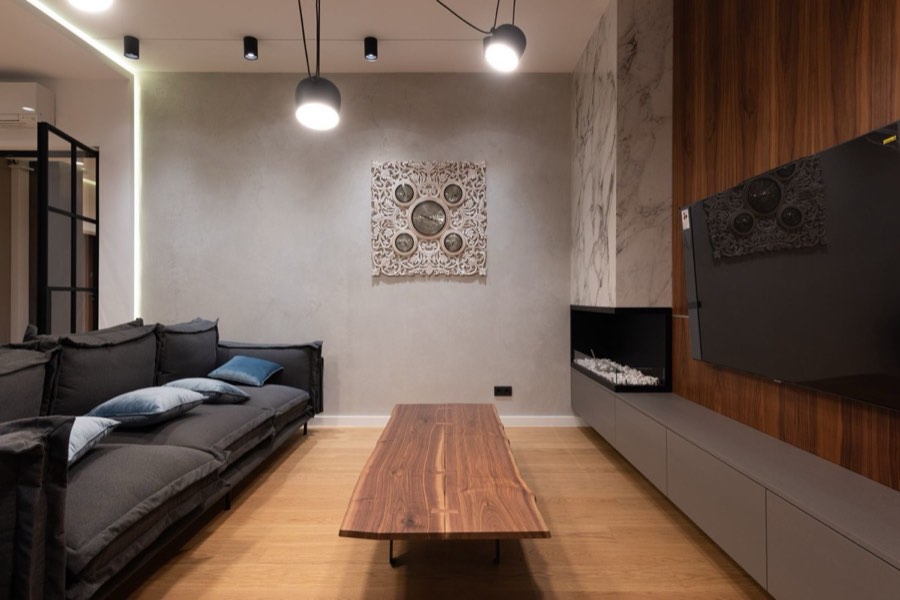 TV mounted on a wood-panel feature wall in a modern condo living room